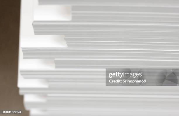 stack white paper isolated on white background with clipping path. stack of blank paper. paper stack in bin of offset printing press. - selective focus with noise and blur - printer paper stack stock pictures, royalty-free photos & images