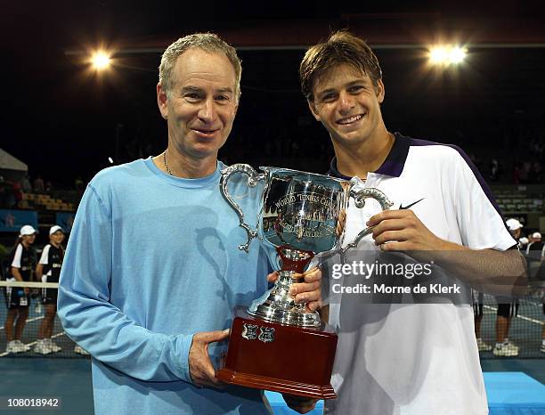 John McEnroe and Ryan Harrison of Team USA poses with their trophy for winning the tournament after day three of the World Tennis Challenge at...