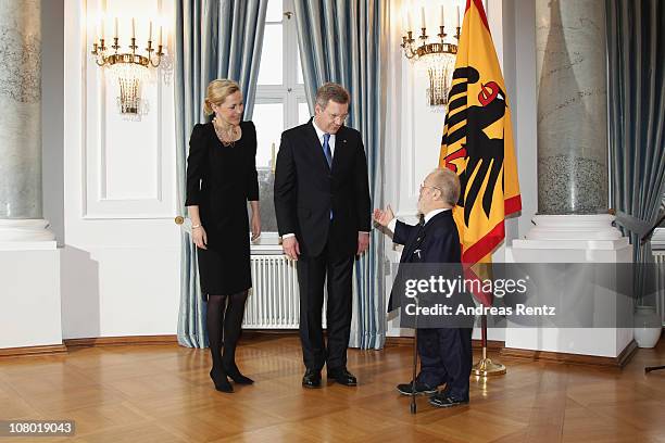 German President Christian Wulff and German First Lady Bettina Wulff welcome Robert Antretter during the New Year's reception at Bellevue Palace on...