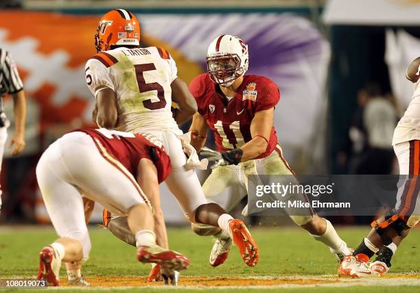 Linebacker Shayne Skov of the Stanford Cardinal attempts to chase down Tyrod Taylor of the Virginia Tech Hokies during the 2011 Discover Orange Bowl...