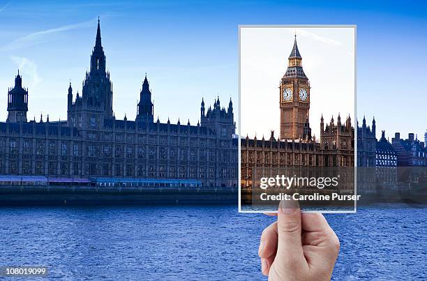 hand holding up postcard of big ben/westminster - holiday postcard stock pictures, royalty-free photos & images