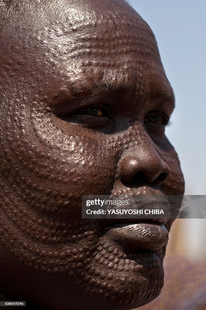 A southern Sudanese woman waits for food