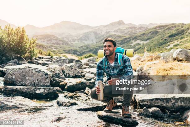 happy hiker by a mountain stream - thirsty stock pictures, royalty-free photos & images