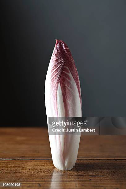 red chicory on old table - chicory stock pictures, royalty-free photos & images