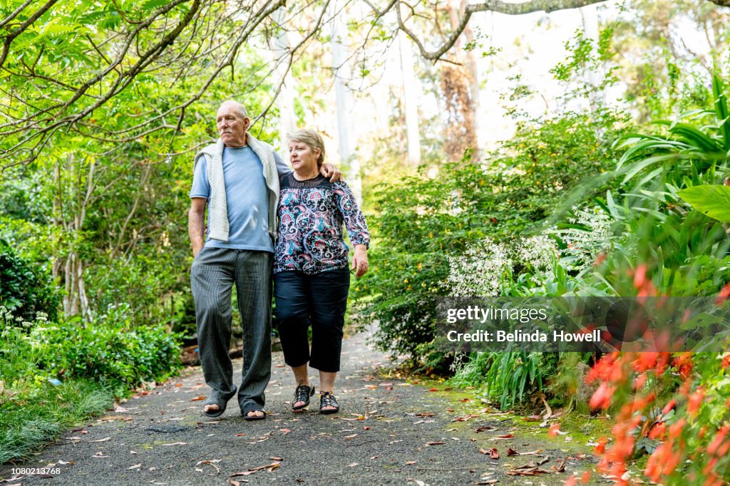Healthy and physically active senior Australian couple picnic in a rainforest