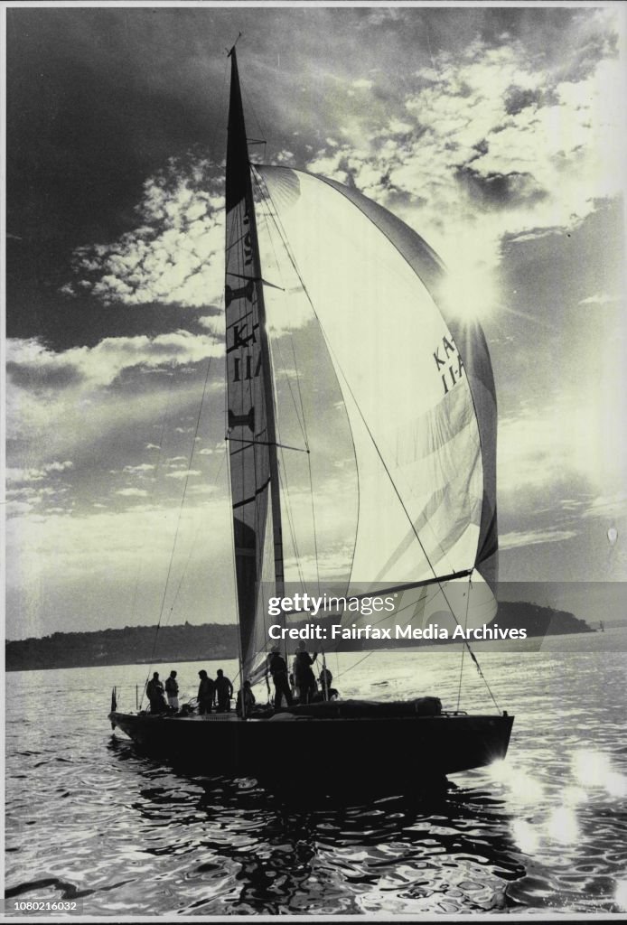 Kevin Parry's contender for the Americas Cup "Kookaburra" silhouetted against a harbor background.
