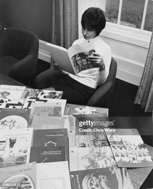 Staff member reads through a leaflet prepared for students at home, at the Open University campus at Walton Hall, Milton Keynes, Buckinghamshire,...