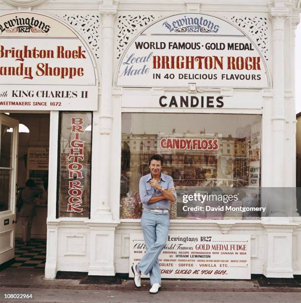 British entertainer Max Bygraves outside a sweetshop in Brighton, circa 1980.