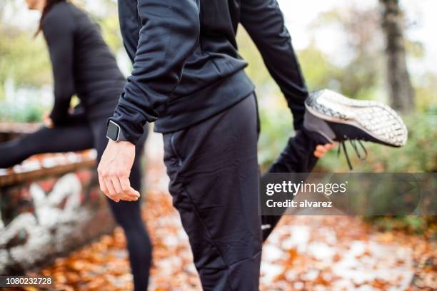 warming up in the park - warming up for exercise stock pictures, royalty-free photos & images