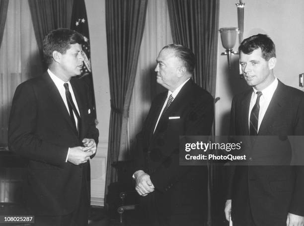 President John F. Kennedy meets with FBI Director J. Edgar Hoover , while his brother, Attorney General Robert F. Kennedy . Stands with them in the...