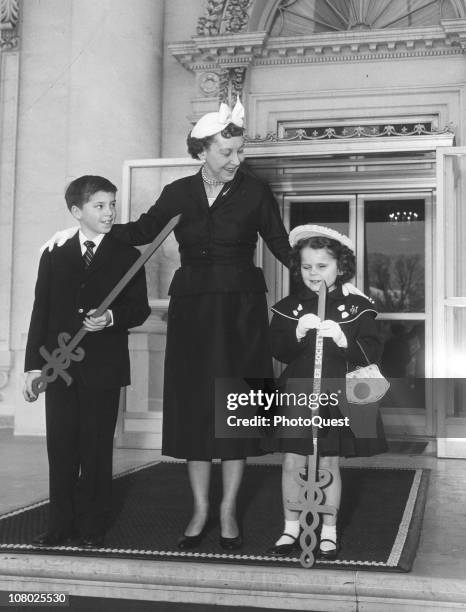 At the White House, US First Lady Mamie Eisenhower poses with two unidentified children as she helps to kick off the 1959 American Cancer Society...