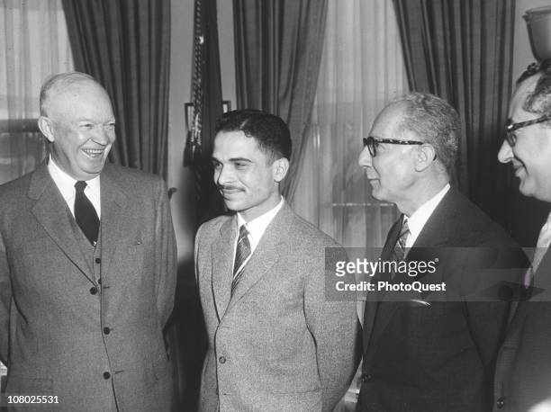 President Dwight Eisenhower shares a laugh with King Hussein of Jordan and unidentified others in the White House, Washington DC, March 25, 1959.
