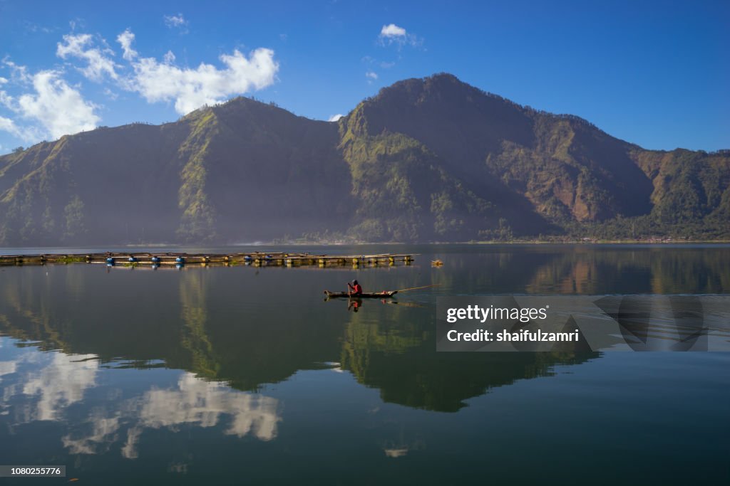 Morning scene of Lake Batur with fisherman daily activity.