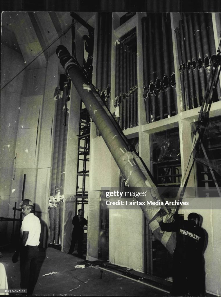 At the Opera House today the largest organ pipe weighting 950lb was lifted into place with the other pipes.The pipe in lifted into place it was placed in position ***** standing at left.The largest of the tin pipes is lifted into position. It was placed w