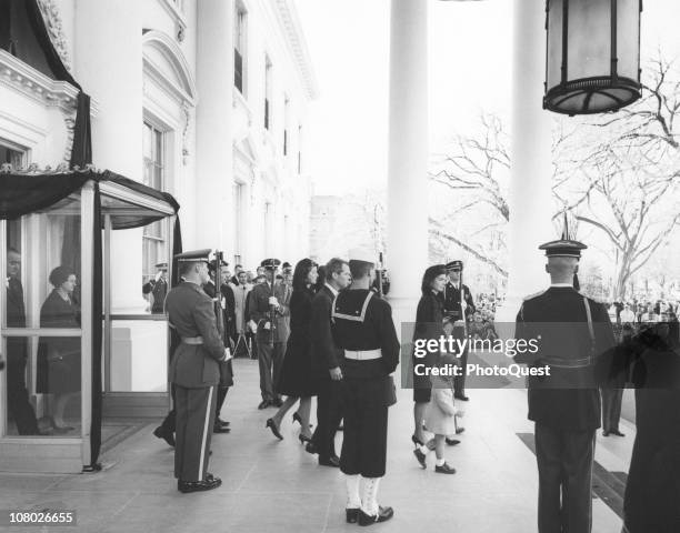 Jacqueline Kennedy , accompanied by her children, John Kennedy Jr and Caroline Kennedy, and her brother-in-law, Ted Kennedy leaves the White House...