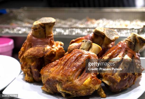 roasted pork leg with fried potatoes - scheenbeen stockfoto's en -beelden