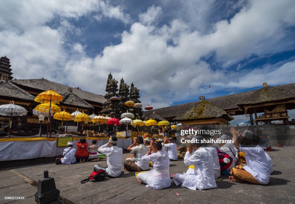 Balinese people praying in a temple Pura Besakih, Bali, Indonesia.