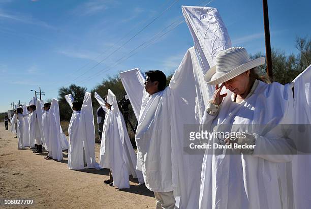 Jody Lee Duek and members of the 'Angel Project' stand along the street leading to the St. Elizabeth Ann Seton church for the funeral of...