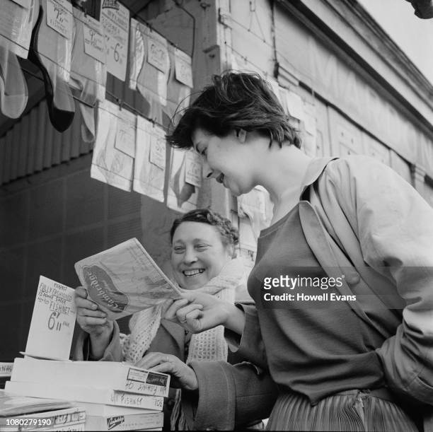English writer Shelagh Delaney buying stockings in Stratford Market, East London, UK, 1958. 'The British Sagan from Salford' Images)