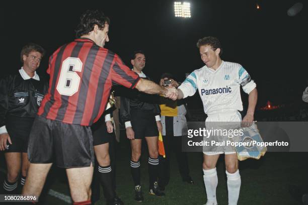 View of Franco Baresi, captain of AC Milan shaking hands and swapping pennants with Jean-Pierre Papin, captain of Olympique de Marseille prior to...