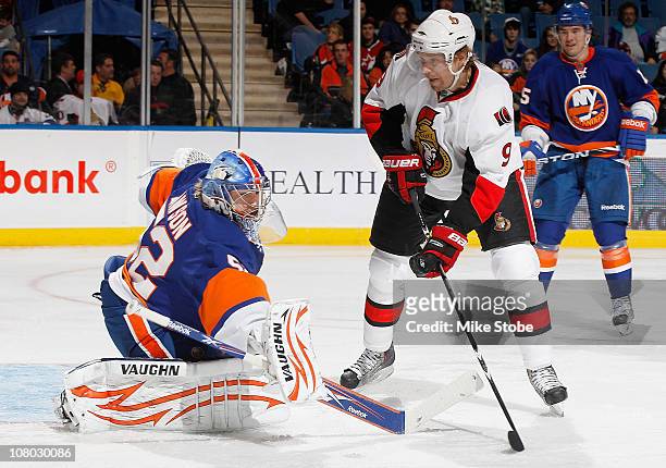 Goaltender Matt Lawson of the New York Islanders makes a save as Milan Michalek of the Ottawa Senators battles in front of the net on January 13,...