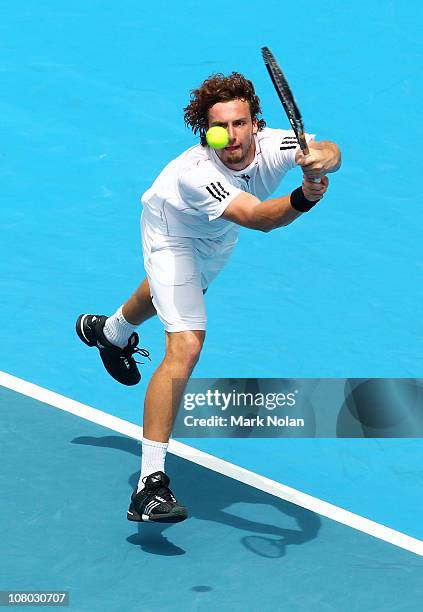 Ernests Gulbis of Lativa hits a backhand in his semi final match aginst Gilles Simon of France during day six of the 2011 Medibank International at...