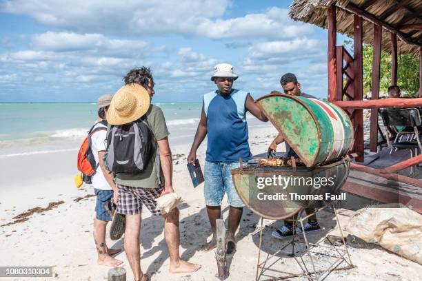 cooking lobster on a oil drum bbq on the beach in cuba - resourceful stock pictures, royalty-free photos & images