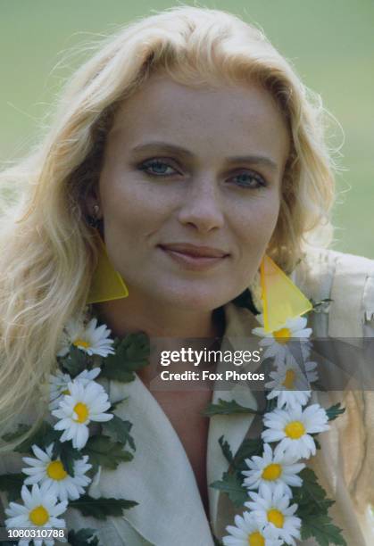 Danish-born model and actress Merete Van Kamp, star of the television mini-series 'Princess Daisy', wearing an artificial daisy chain, 1984.