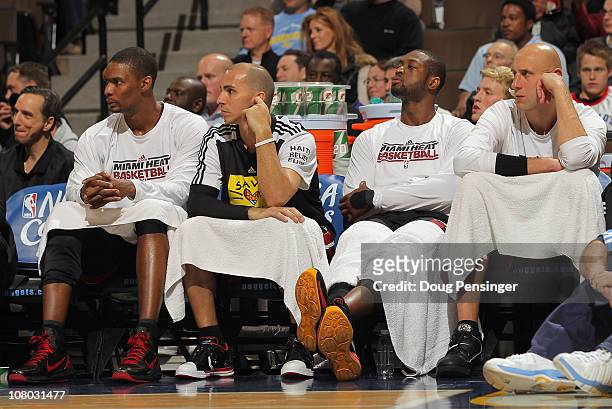 Chris Bosh, Carlos Arroyo, Dwyane Wade and Zydrunas Ilgaukas of the Miami Heat sit on the bench in the fourth quarter against the Denver Nuggets at...