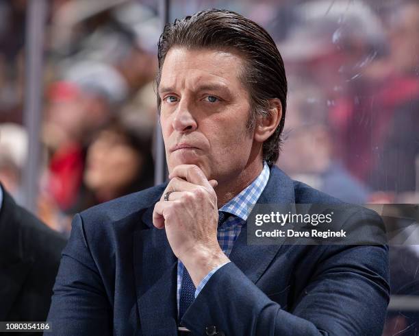 Assistant coach Lane Lambert of the New York Islanders watches the action from the bench against the Detroit Red Wings during an NHL game at Little...