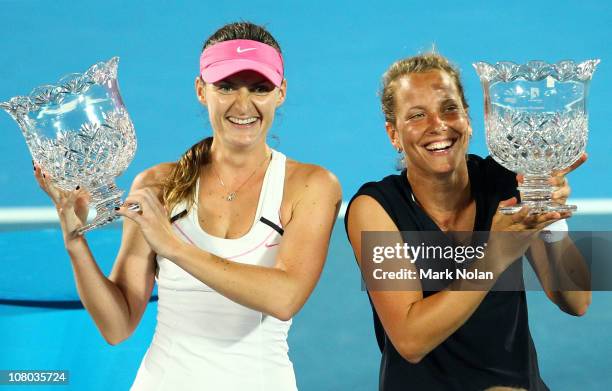 Iveta Benesova and Barbora Zahlavova Strycova of the Czech Republic hold trophies after winning the womens doubles final against Kveta Peschke of the...