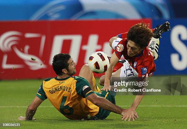 Sasha Ognenovski of Australia tackles Lee Chung Yong of Korea Republic during the AFC Asian Cup Group C match between the Australian Socceroos and...