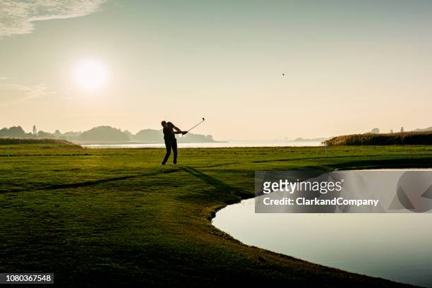 hitting the perfect pitch shot. - golf stock pictures, royalty-free photos & images