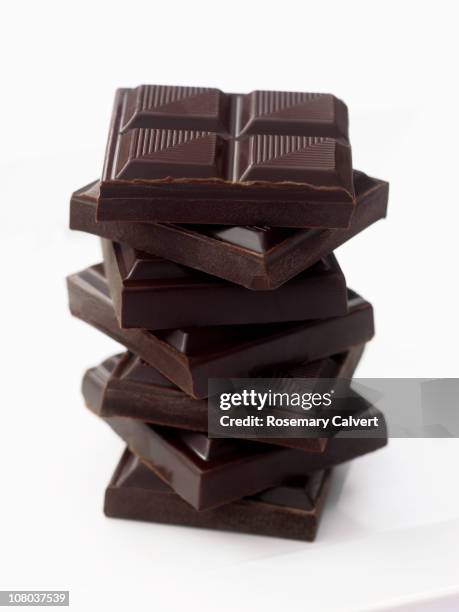 slabs of chocolate piled up to form tower. - dark chocolate stock pictures, royalty-free photos & images