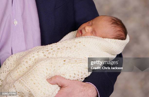 Crown Prince Frederik of Denmark holds a new-born baby twin as they leave the Rigshospitalet on January 14, 2011 in Copenhagen, Denmark. Princess...