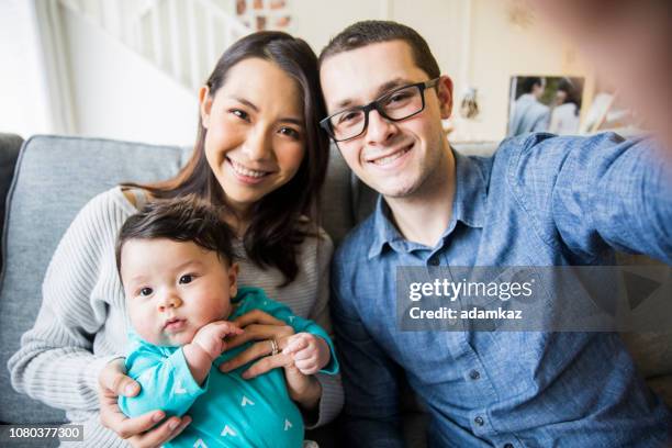 young diverse family taking a selfie - chinese family taking photo at home stock pictures, royalty-free photos & images