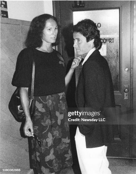 Dr. Renee Richards and Mary Carillo wait outside the courtroom at the Supreme Court in Riverhead, New York on September 25, 1986 during Martina...