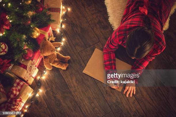 little girl writing a letter to santa claus - child writing stock pictures, royalty-free photos & images
