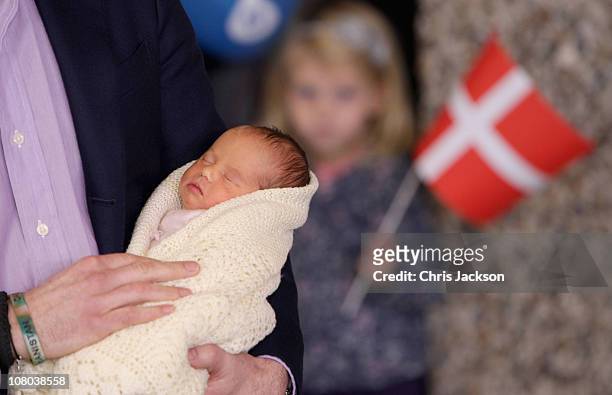 Crown Prince Frederik of Denmark holds a new-born baby twin as they leave the Rigshospitalet on January 14, 2011 in Copenhagen, Denmark. Princess...