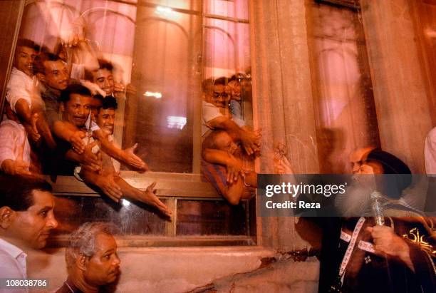 The Pope Chenouda III bless followers during the Coptic Christmas ceremony, celebrated in the Cathedral of St Mark in Cairo on the night of 6th to...