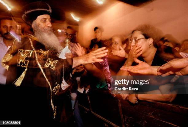 The Pope Chenouda III bless followers during the Coptic Christmas ceremony, celebrated in the Cathedral of St Mark in Cairo on the night of 6th to...