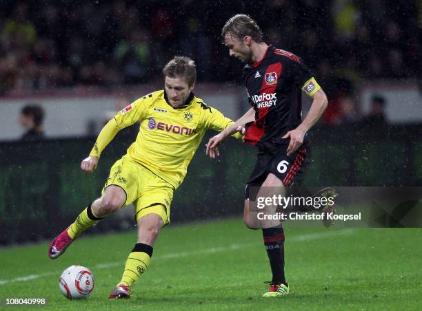 Simon Rolfes of Leverkusen challenges Jakub Blaszczykowski of Dortmund during the Bundesliga match between Bayer Leverkusen and Borussia Dortmund at...