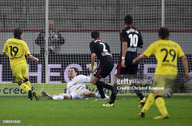 Kevin Grosskreutz of Dortmund scores the first goal against Rene Adler , Daniel Schwaab and Renato Augusto of Leverkusen during the Bundesliga match...