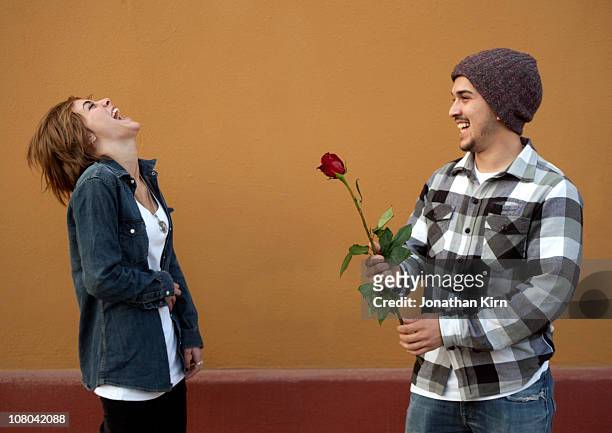 young couple in love. - man giving flowers stock pictures, royalty-free photos & images