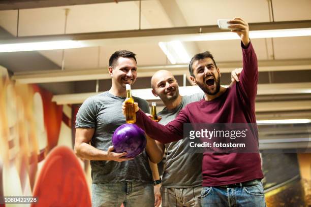 friends taking selfie in bowling alley - bowling for buddies stock pictures, royalty-free photos & images