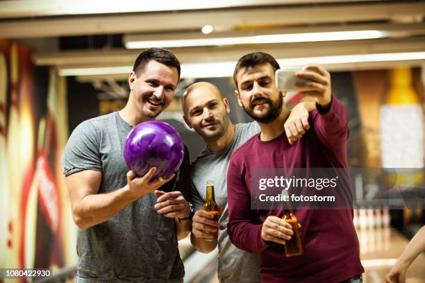 friends taking selfie in bowling alley - bowling for buddies stock pictures, royalty-free photos & images