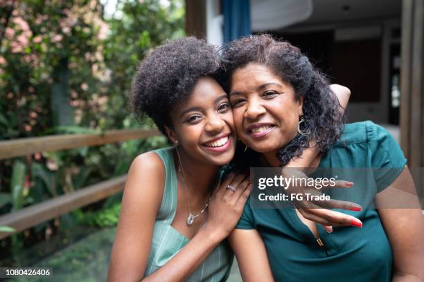 mère et fille embrassant à la maison - black mom photos et images de collection