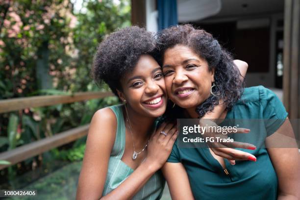 mother and daughter embracing at home - brazilian culture stock pictures, royalty-free photos & images