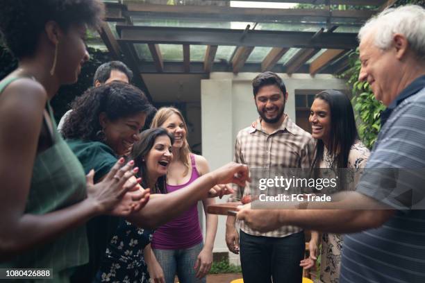 serving meat at barbecue party - reunion social gathering stock pictures, royalty-free photos & images