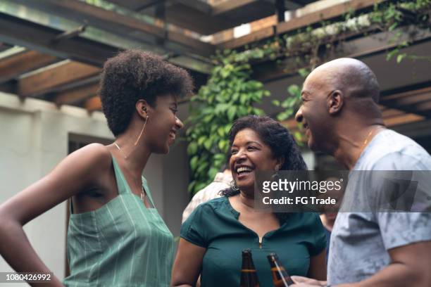 family enjoying a barbecue day at home - barbecue social gathering stock pictures, royalty-free photos & images